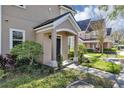 Inviting front entrance with charming landscaping and a covered porch area at 3398 Greenwich Village Blvd # 104, Orlando, FL 32835