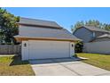 Charming home featuring a two-car garage and manicured front lawn at 3605 S Saint Lucie Dr, Casselberry, FL 32707