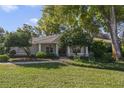 Charming single-story home with a well-manicured lawn, lush landscaping and a tile roof at 400 W 2Nd Ave, Windermere, FL 34786