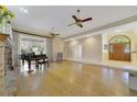 Spacious living room with wood floors, a large window, fireplace and traditional furnishings at 400 W 2Nd Ave, Windermere, FL 34786