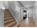 Inviting foyer with hardwood flooring and a staircase to the upper level at 418 Marcello Blvd, Kissimmee, FL 34746