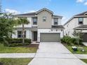 Beautiful two-story home with a well-manicured lawn, perfect for curb appeal at 418 Marcello Blvd, Kissimmee, FL 34746