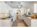 Clean kitchen with white appliances, ample counter space, and a view into the living area at 421 Blackbird Way, Kissimmee, FL 34759