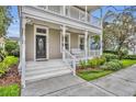 Inviting front porch with classic white railings and trim, leading to the home's entrance at 5492 Penway Dr, Orlando, FL 32814