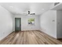 Bright living room with new floors, fresh paint and contemporary ceiling fan at 5603 Marie Ct, Orlando, FL 32818