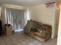 View of the living room, featuring tile flooring, a window and a couch at 5855 La Costa Dr # S, Orlando, FL 32807