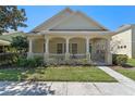 Charming single-story home with a covered front porch, columns, and manicured lawn at 6610 Helston Ln, Windermere, FL 34786