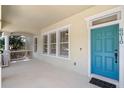 Inviting front porch with a turquoise door and space for seating at 6610 Helston Ln, Windermere, FL 34786