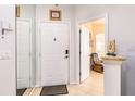 Home entryway featuring a white front door, tile flooring, and an open view to the living area at 698 Seabrook Ct # 103, Altamonte Springs, FL 32714