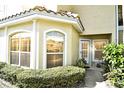 Townhouse exterior with white trim, arched windows, well-maintained landscaping, and inviting front entrance at 698 Seabrook Ct # 103, Altamonte Springs, FL 32714
