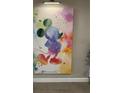 Bright and colorful abstract Mickey Mouse artwork provides a whimsical accent to the room at 8008 Formosa Valley Pl, Kissimmee, FL 34747