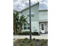 Two-story townhome showcases modern architecture, lush landscaping, and a welcoming front door at 8008 Formosa Valley Pl, Kissimmee, FL 34747