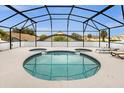 Unique Mickey Mouse-shaped pool is screened-in and features an attached hot tub at 8073 Santee Dr, Kissimmee, FL 34747