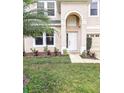 Two-story home showcasing a manicured front lawn with fresh mulch beds and vibrant greenery at 10071 Cypress Knee Cir, Orlando, FL 32825