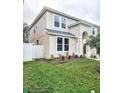 Two-story home exhibiting manicured front lawn with fresh mulch beds and vibrant greenery at 10071 Cypress Knee Cir, Orlando, FL 32825