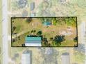 Aerial view of property outlining generous lot size, landscaping, and outbuildings at 15765 Sunflower Trl, Orlando, FL 32828