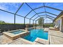 Stunning screened-in pool and spa featuring water features and beautiful deck seating at 16736 Broadwater Ave, Winter Garden, FL 34787