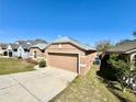 Side view showcasing the house's facade, driveway, and landscaping details at 2073 Newtown Rd, Groveland, FL 34736