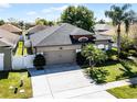 Charming home featuring a spacious two-car garage, neatly trimmed bushes, and verdant, green grass at 2258 Crystal Falls Way, Orlando, FL 32824