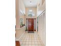 Bright foyer features tile flooring, high ceilings, and a decorative light fixture at 2821 Lone Feather Dr, Orlando, FL 32837