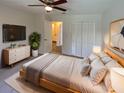 Comfortable bedroom featuring a ceiling fan, a closet, and a view into the attached bathroom at 2835 Abney Ave, Orlando, FL 32833