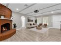 Inviting living room with a brick fireplace, hardwood floors, and lots of natural light at 3052 Saratoga Dr, Orlando, FL 32806