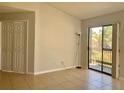 Living room features tiled floor and glass sliding door out to a screened balcony at 3772 Idlebrook Cir # 210, Casselberry, FL 32707