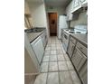 Efficient kitchen with white appliances and cabinets, maximized for space in the condo at 413 Summit Ridge Pl # 115, Longwood, FL 32779