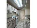 Condo kitchen with updated white cabinets and appliances, offering a functional space at 413 Summit Ridge Pl # 115, Longwood, FL 32779