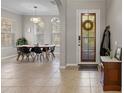 Light-filled dining room with tiled floors, large windows, and stylish dining set perfect for entertaining at 4474 Virginia Dr, Orlando, FL 32814