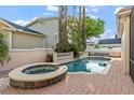 Backyard pool and spa surrounded by brick pavers, lush landscaping, and private patio area at 4474 Virginia Dr, Orlando, FL 32814