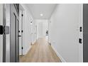 Bright hallway with wood-look flooring, leading to various rooms in the home at 5790 Crystal Beach Rd, Winter Haven, FL 33880