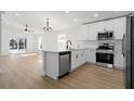 Modern kitchen featuring stainless steel appliances, white cabinetry, and an island at 5790 Crystal Beach Rd, Winter Haven, FL 33880