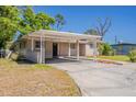 Single-story home with covered parking area and small landscaping at 5909 Avery St, Orlando, FL 32808