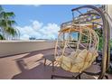 Enjoy city views and relax in style on this amazing rooftop deck with a unique hanging chair and table at 6165 Carrier Dr # 3512, Orlando, FL 32819