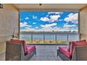 Relaxing balcony with comfortable seating and panoramic views of the lake and skyline at 8743 The Esplanade # 11, Orlando, FL 32836