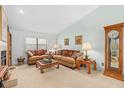 Cozy living room featuring a fireplace, plush sofas, and bright natural light from the windows at 9109 Galleon Dr, Orlando, FL 32819