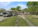 Single-story house featuring a covered parking area and well-lit exterior at 941 Grey Oak Ct, Orlando, FL 32809