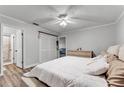 Bright bedroom with neutral walls, wood-look floors, closet and a king bed at 1234 Villa Ln # S, Apopka, FL 32712