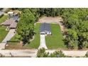 An aerial view of a new home with a spacious, green lawn surrounded by mature trees at 13457 Sw 53Rd St, Ocala, FL 34481