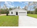 Charming one-story home featuring a well-manicured lawn, attached two car garage, and modern curb appeal at 13457 Sw 53Rd St, Ocala, FL 34481