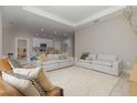 Bright open-concept living room with two couches, open to the kitchen with a center island at 13457 Sw 53Rd St, Ocala, FL 34481