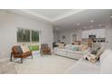 Cozy living room with view to backyard, and a kitchen that features white cabinets at 13457 Sw 53Rd St, Ocala, FL 34481