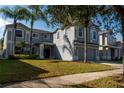 Charming two-story home featuring a well-manicured lawn, mature trees, and a welcoming front entrance at 13545 Fox Glove St, Winter Garden, FL 34787