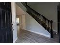 Inviting foyer with new floors and a staircase with dark wood banister at 13545 Fox Glove St, Winter Garden, FL 34787