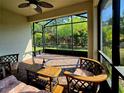 Relaxing screened-in patio featuring comfortable seating and views of the lush backyard at 225 Vestrella Dr, Kissimmee, FL 34759