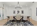 Elegant dining room with a modern chandelier, dining table with seating for eight and a stylish rug at 257 New Gate Loop, Lake Mary, FL 32746