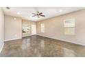 Bright, open living room with polished concrete floors and abundant natural light at 2956 Whispering Trails Dr, Winter Haven, FL 33884