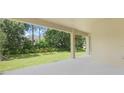 Covered patio offering a serene outdoor living space with views of the landscaped backyard at 3036 Country Side Dr, Apopka, FL 32712