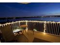 Charming outdoor seating on the balcony with decorative string lights and distant city view at 6336 Buford St # 602, Orlando, FL 32835